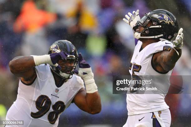 Brandon Williams pretends to photograph teammate linebacker Terrell Suggs of the Baltimore Ravens after his sack on quarterback Nathan Peterman of...