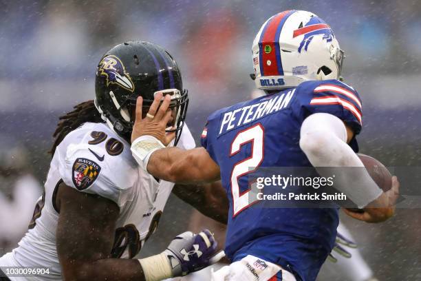 Quarterback Nathan Peterman of the Buffalo Bills stiff arms linebacker Za'Darius Smith of the Baltimore Ravens in the second quarter against the...