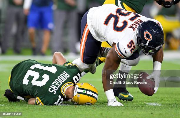 Aaron Rodgers of the Green Bay Packers lays on the ground after injuring his leg in the second quarter of a game against the Chicago Bears at Lambeau...