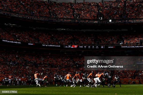 Case Keenum of the Denver Broncos fires a pass to Phillip Lindsay against the Seattle Seahawks during the Broncos 27-24 win at Broncos Stadium at...