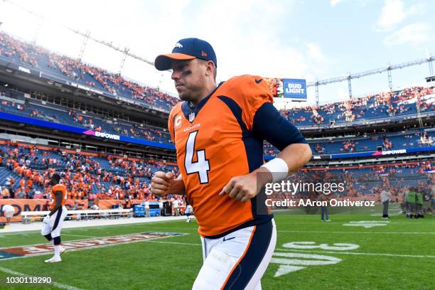 Case Keenum of the Denver Broncos jogs off the field after the Broncos 27-24 win over the Seattle Seahawks at Broncos Stadium at Mile High in Denver,...