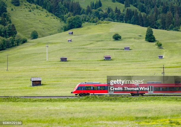 commuter train in a agricultural landscape - commuter train stock pictures, royalty-free photos & images