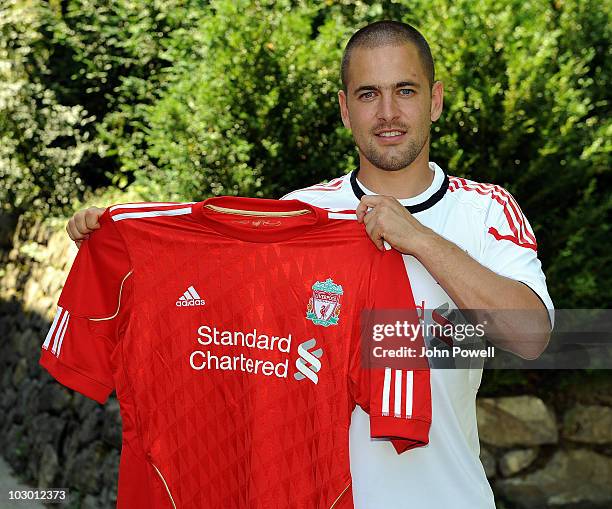 Liverpool FC new signing Joe Cole holds up a Liverpool shirt at the club's pre-season Swiss Training Camp on July 21, 2010 in Bad Ragaz, Switzerland.