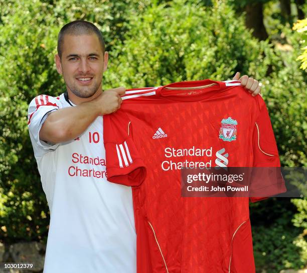 Liverpool FC new signing Joe Cole holds up a Liverpool shirt at the club's pre-season Swiss Training Camp on July 21, 2010 in Bad Ragaz, Switzerland.