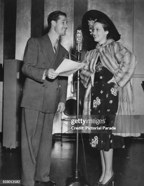 Actor Don Ameche and actress Dorothy Lamour with an NBC microphone in a publicity image for the radio show, 'The Chase and Sanborn Hour', USA, 20 May...