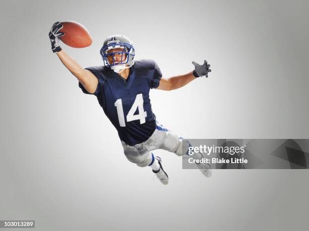 studio football player - american football player catch stock pictures, royalty-free photos & images