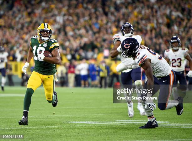 Randall Cobb of the Green Bay Packers runs in for a touchdown past Leonard Floyd of the Chicago Bears during the fourth quarter of a game at Lambeau...