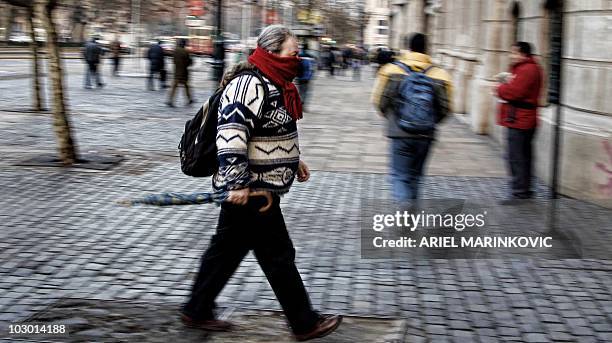 Man with warm clothes walks along downtown Santiago July 21, 2010. Chile faces the coldest winter of the last three years, and has sustained losses...