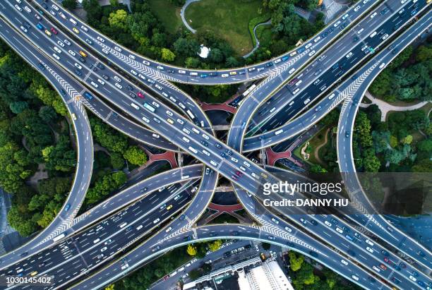 directly above view of road junction in shanghai - road intersection stock-fotos und bilder