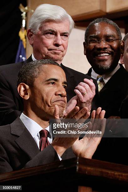 President Barack Obama applauds after signing the the financial reform bill into law during a ceremony with Senate Banking Committee Chairman...