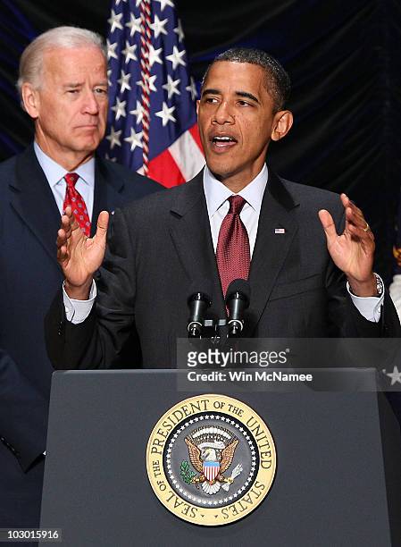 President Barack Obama speaks as Vice President Joe Biden looks on before signing the Dodd-Frank Wall Street Reform and Consumer Protection Act at...