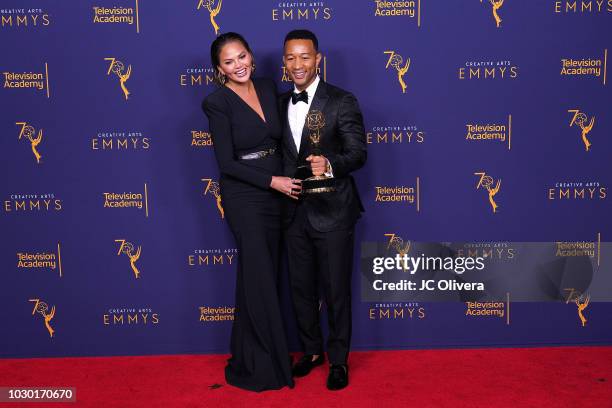 John Legend, winner of the award for outstanding variety special for 'Jesus Christ Superstar Live in Concert', and wife Chrissy Teigen pose in the...