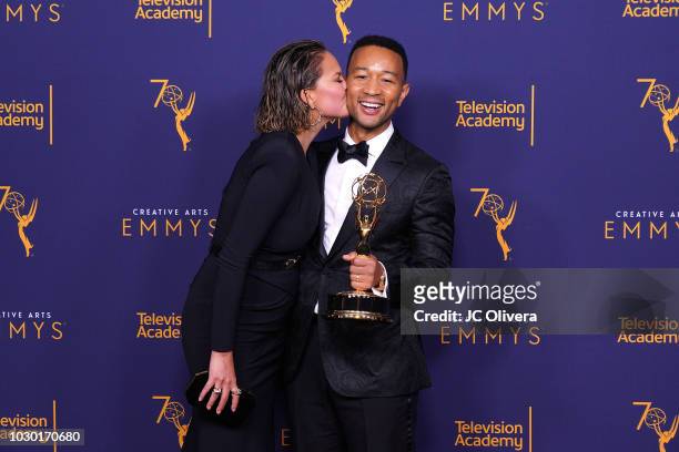 John Legend, winner of the award for outstanding variety special for 'Jesus Christ Superstar Live in Concert', and wife Chrissy Teigen pose in the...