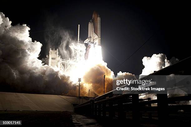 space shuttle endeavour lifts off into the night sky from kennedy space center. - endeavour stockfoto's en -beelden