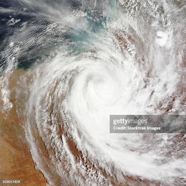 cyclone laurence moves far inland over western australia. - australia from space stock-fotos und bilder