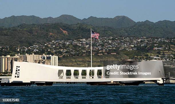 the ensign flies over the arizona memorial. - uss arizona memorial stock pictures, royalty-free photos & images