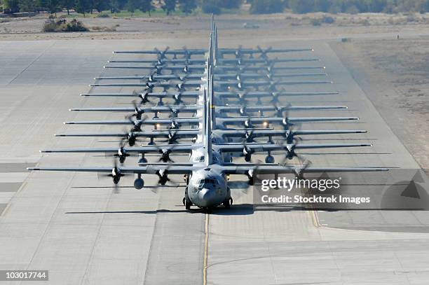 a line of c-130 hercules taxi at nellis air force base, nevada. - nellis air force base stock pictures, royalty-free photos & images