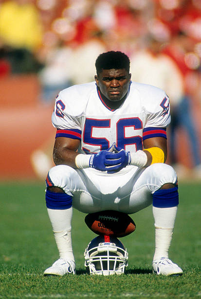 Linebacker Lawrence Taylor of the New York Giants in this portrait sitting on his helmet December 3, 1990 before an NFL football game against the San...