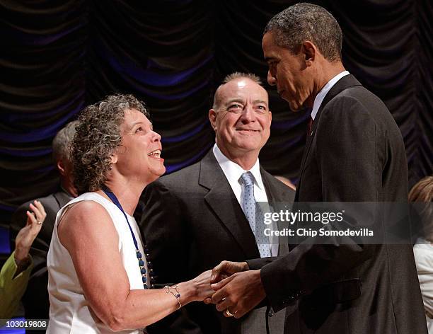 President Barack Obama greets Robin Fox and Andrew Giordano before signing the financial reform bill into law during a ceremony at the Ronald Reagan...