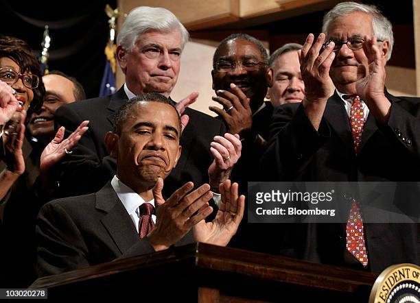 President Barack Obama applauds after signing the Dodd-Frank Wall Street Reform and Consumer Protection Act during a ceremony at the Ronald Reagan...