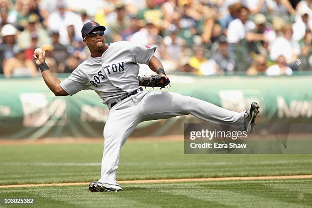 Adrian Beltre of the Boston Red Sox makes a play on a bunt by Rajai Davis of the Oakland Athletics at the Oakland-Alameda County Coliseum on July 21,...