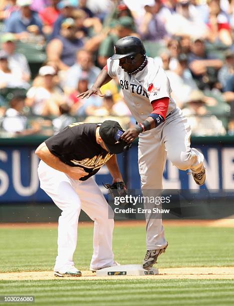 Bill Hall of the Boston Red Sox beats the tag of Kevin Kouzmanoff of the Oakland Athletics to steal third base in the fifth inning at the...