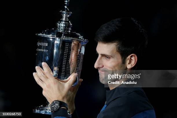 Novak Djokovic of Serbia holds the championship trophy after winning his men's singles finals match against Juan Martin Del Potro of Argentina at US...