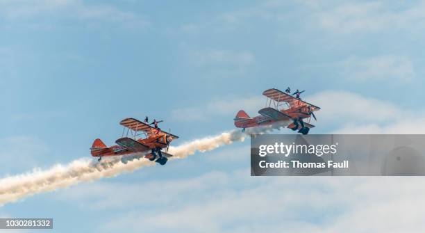 two wing walkers on old biplanes at the bournemouth air festival - airshow stock pictures, royalty-free photos & images