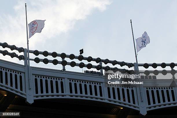 Flags at Yankee Stadium fly at half mast in honor of late owner George Steinbrenner of the New York Yankees and long time stadium public address...