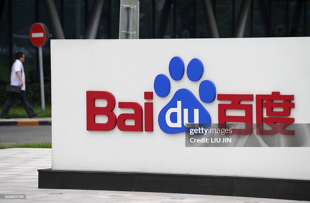 A man walks past the logo of Baidu at it