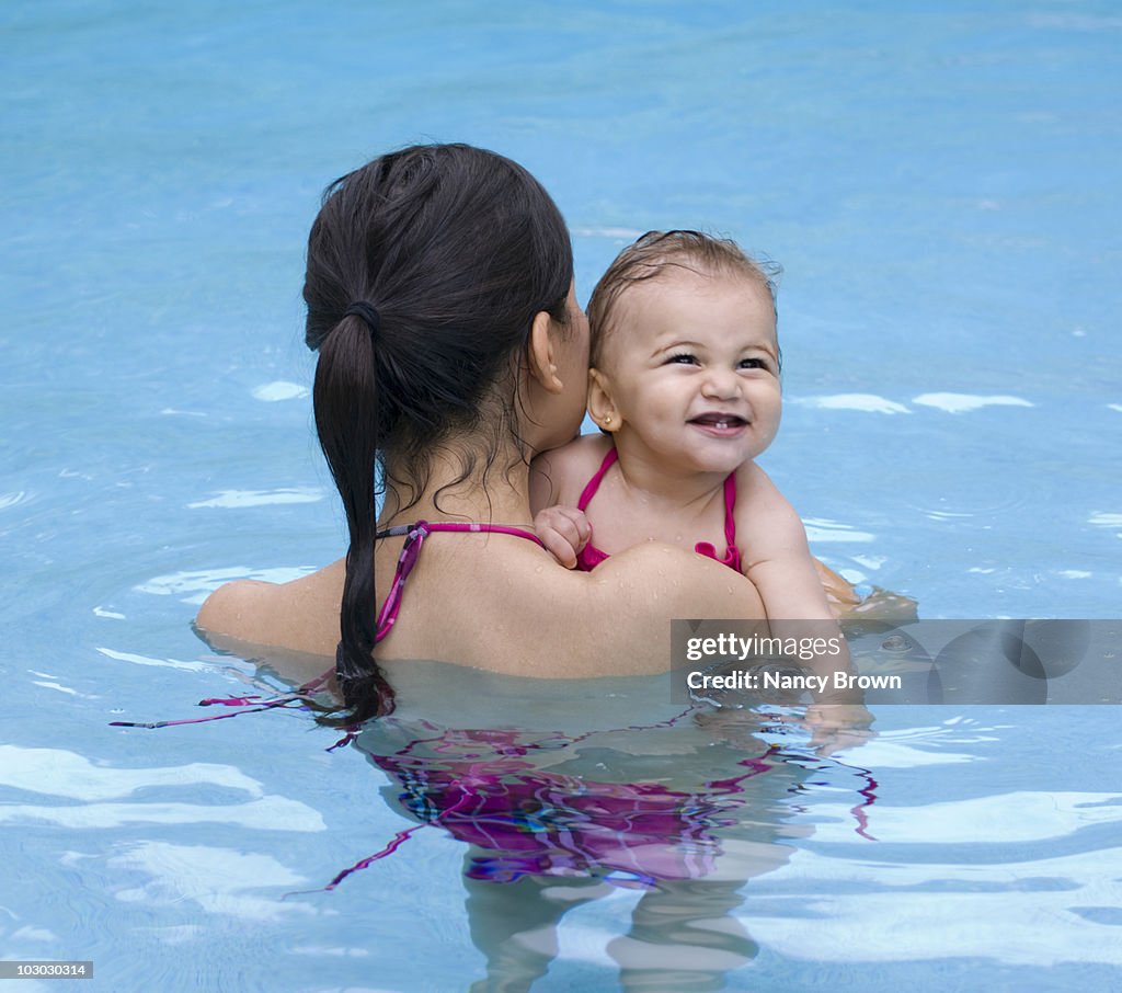 Mother and baby in swimming pool.