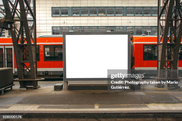 blank billboard at train station - poster wall stock-fotos und bilder