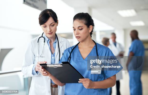 what's next? - nurses looking at chart stock pictures, royalty-free photos & images