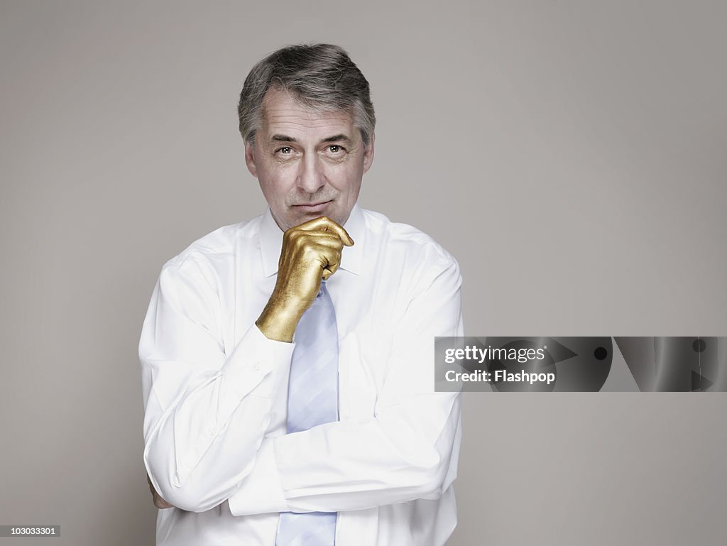 Portrait of businessman with golden hand