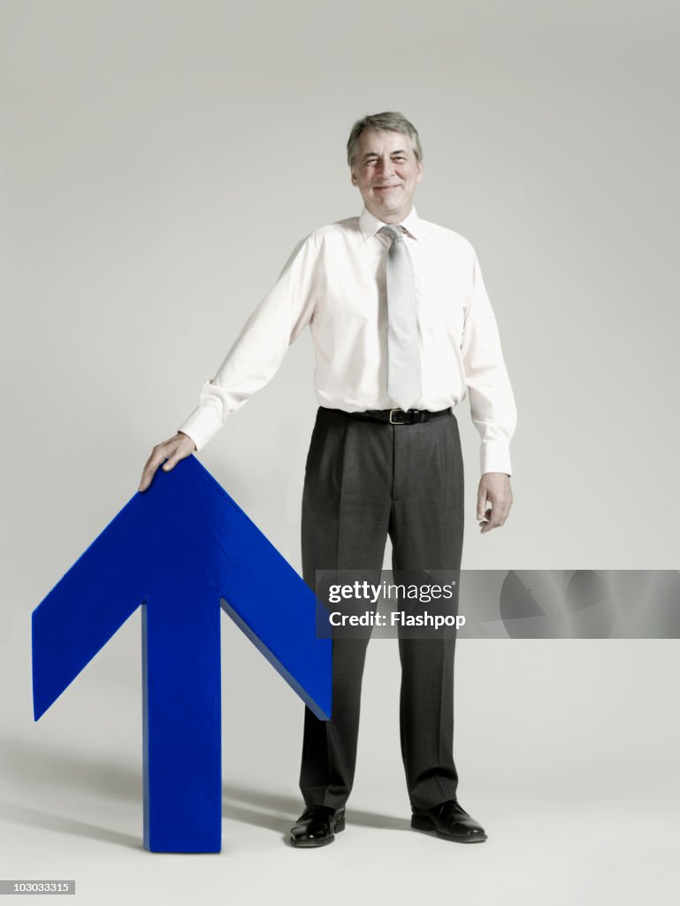 Businessman with blue arrow