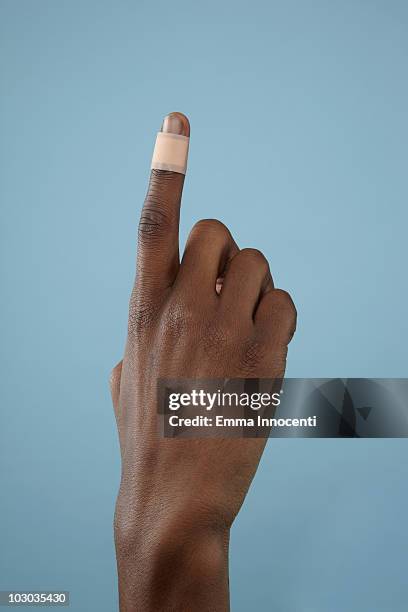 close up of finger with band-aid - 絆創膏 ストックフォトと画像