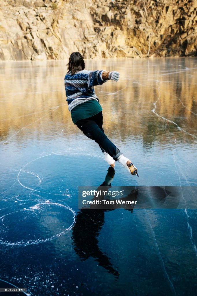 Talented Ice Skater Skating On Frozen Lake