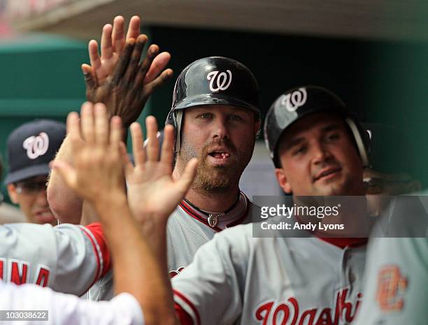 Adam Dunn of the Washington Nationals is congratulated by teammates after hitting a home run during the game against the Cincinnati Reds at Great...