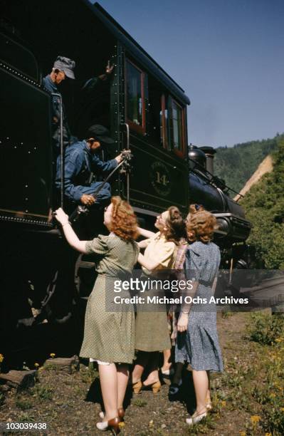 Four women chat with the engineers of the vintage narrow guage steam engine on the East Tennessee & Western North Carolina railway running the 65...