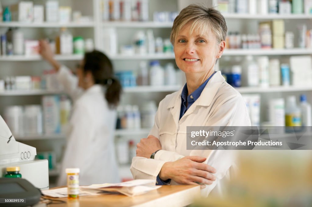 Pharmacists at counter of retail pharmacy