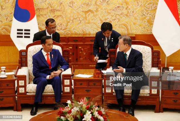 South Korean President Moon Jae-In talks with Indonesian President Joko Widodo before their meeting at the Presidential blue house on September 10,...