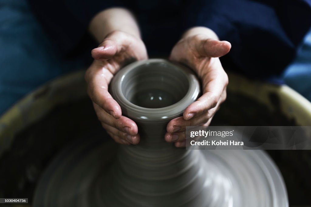 Hands of woman enjoying pottery
