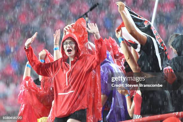 Fan of the Nebraska Cornhuskers waits out a weather delay in the game against the Akron Zips at Memorial Stadium on September 1, 2018 in Lincoln,...