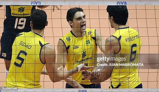 Giba Sidao and Vissotto of Brazil celebrate a point against Sebia during their World League Group E volleyball match at Orfeo Superdomo stadium in...