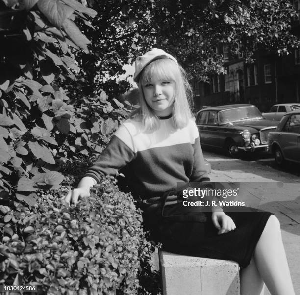English actress Natasha Pyne wearing Frew McMillan's white cap, UK, 19th October 1964.