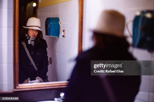 elegant young woman in front of mirror - hand dryer stock pictures, royalty-free photos & images