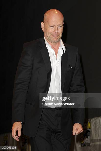 Actor Bruce Willis walks onstage at the "The Expendables" panel during Comic-Con 2010 at San Diego Convention Center on July 22, 2010 in San Diego,...