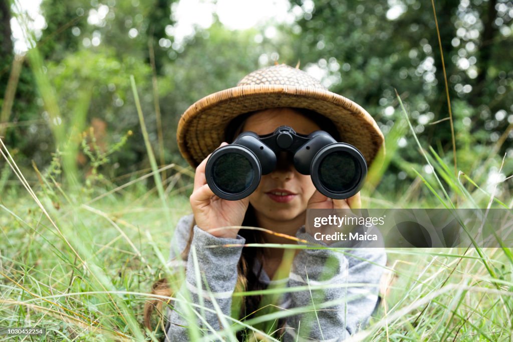 Child looking through binoculars