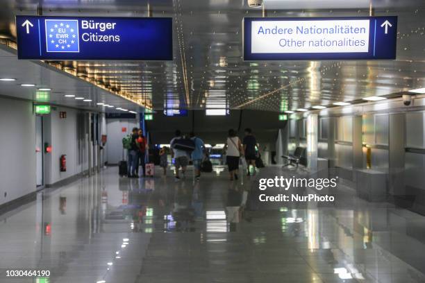 Citizen signs at the arrivals in Dusseldorf International Airport in Germany. There are special lanes to passport control, immigration for EU...