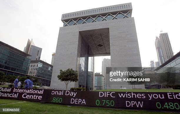 Workers stand outside the Dubai International Financial Center in the Gulf emirate on November 29, 2009. Dubai's shock alert of possible debt default...